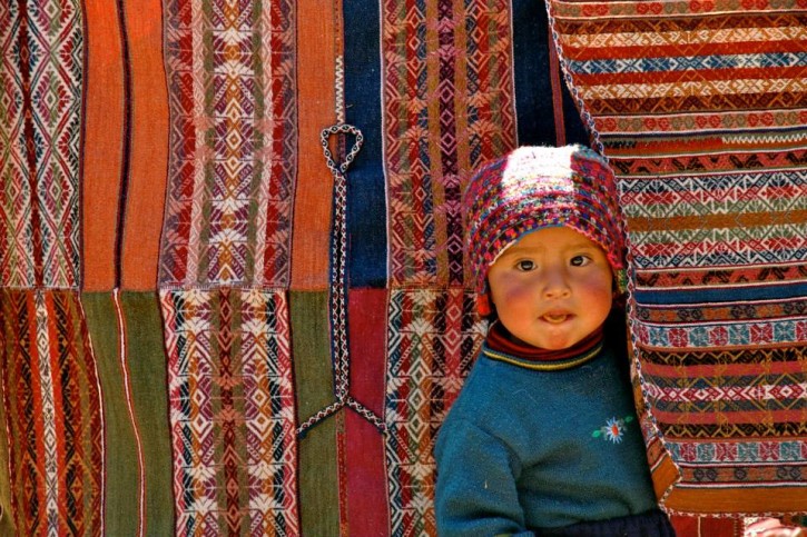 Peru CTTC Weavers Peeking Between Textiles